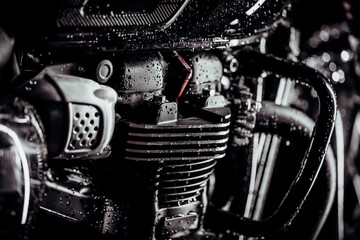Motorcycle at wash after off-road driving. Washing engine with water of classic black motorbike at...