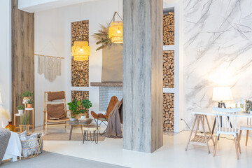 Fashionable modern interior of a light studio apartment with wooden columns in the loft style, decorated with brick, marble and wood with stylish furniture and white walls