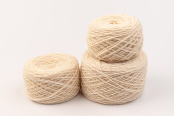 balls of light woolen thread on white background. natural wool. knitting. background