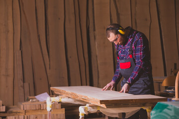 Male carpenter preparing for sanding the board