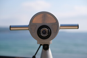 Close up of coin operated monocular on the sea coast