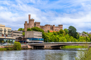 Obraz premium A view from the banks of the River Ness towards castle in Inverness, Scotland on a summers day