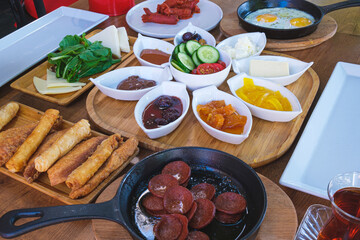 Traditional Turkish breakfast on wooden table in restaurant.
