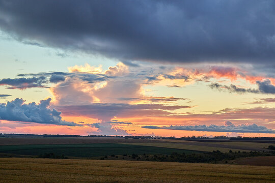 heart shaped cloud over the field, golden sunset, 