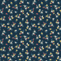 Seamless floral pattern. Liberty background of small colorful flowers. Folk flowers scattered over a dark blue background. Stock vector for printing on surfaces and web design.