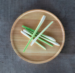 fresh lemongrass on a wooden tray