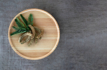 Young tamarind in a wooden tray on the wooden floor