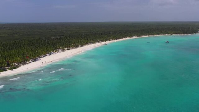 Wide view of Sanoa Island beach and turquoise waters in the Dominican Republic, Aerial wide lowering shot