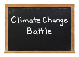 Climate change battle written in white chalk on a black chalkboard isolated on white