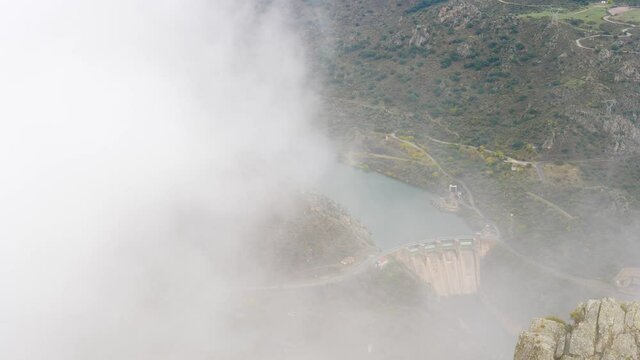 Mountain and Douro river with spanish Saucelle Dam at foggy cloudy weather. Border between Portugal and Spain. National Parks. View from portuguese Penedo Durao lookout.