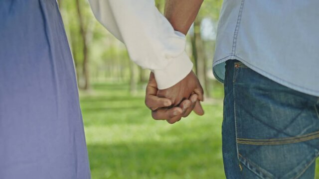 Black Couple Tenderly Crossing Fingers, Holding Hands In Green Park, Close-up