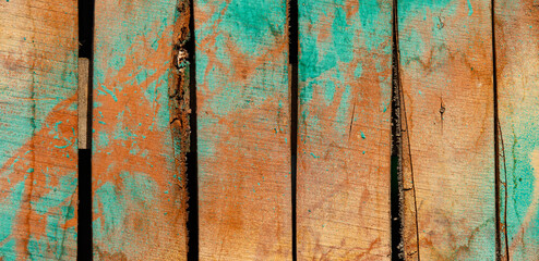 Old with cracks and stains, wooden rustic background, stains of yellow and blue paint.