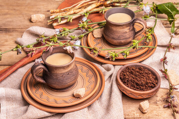 Hot natural chicory caffeine free drink in ceramic cups on a wooden table