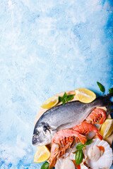 Food background with sea fish on blue.
