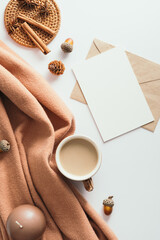Autumn flat lay composition with romantic letter, brown scarf, coffee cup, cinnamon sticks, candle...