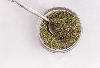 Set of dried ground Italian herbs on a light background. Copy space