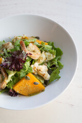 Bowl of fresh vegetarian seafood salad with pumpkin