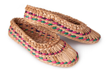 Souvenir bast shoes, woven from a vine on a white background. Ethnic shoes