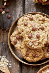 Oatmeal Chocolate Chip Cookies. Wooden background, top view, eggs, oatmeal, flour, chocolate chips, ingredients, milk, butter, rustic.