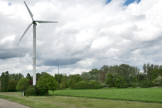 Karlsruhe, Maxau Germany: Wind turbine with thunderstorm sky and green landscape