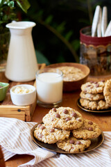 Oatmeal Chocolate Chip Cookies. Wooden table, side view, milk, chocolate, oatmeal.
