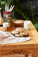Oatmeal Chocolate Chip Cookies. Wooden table, side view, milk, chocolate, oatmeal.
