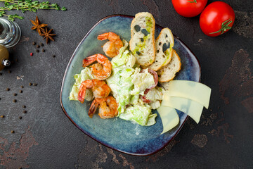 salad caesar with shrimps top view on brown table