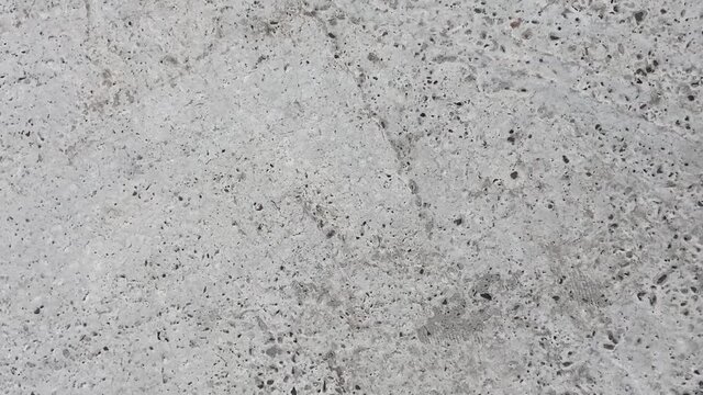 Gray uneven concrete coating with cracks and textures 