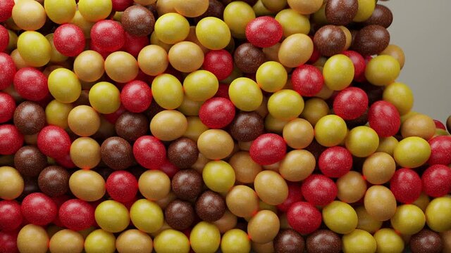 Multicoloured sugar sweets, candy beans or peanuts. Colorful candies filling all the area. Close up video. Holiday mood. Tasty assorted yellow, red, brown colored sweets. 3D Render clip. 4K animation