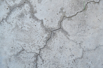 Crack wall texture. Cracked concrete wall covered with cement surface as background. Wall fragment with scratches and cracks