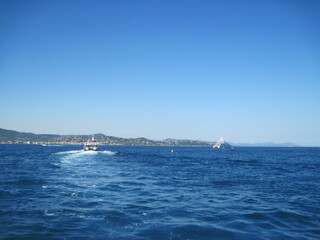 sailboat in the sea. Scenic shore line with view of the town on a sunny day