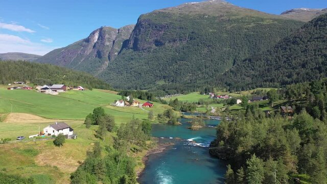 Lake bottom Loenvatnet with glacial river starting to flow dowm Lodalen valley - Forward moving aerial