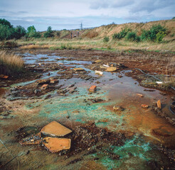 Chemicals leaching to the surface of derelict land from buried toxic waste, West Midlands.