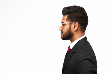 Handsome indian businessman on white background, copy space.