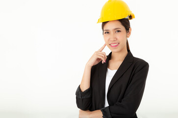 Portrait young attractive Engineer, entrepreneur or architect business woman smiling and wearing yellow hard hat with white background copy space at studio. Pretty asia female confident Pretty lady.