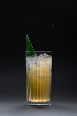 refreshing lemonade drink or cocktail with ice cube in glass on black background