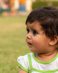 cute indian girl playing in the park.