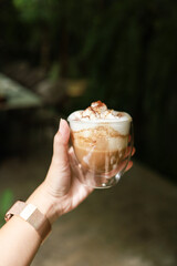 Woman hands  holding cup of coffee with latte art. holding cup of tea or coffee in the morning
