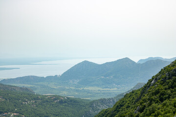 National Park lake Skadar and mountains Dinar highlands of the foggy morning. The largest lake on the Balkans, Montenegro. Popular tourist destination and beautiful nature landscape.