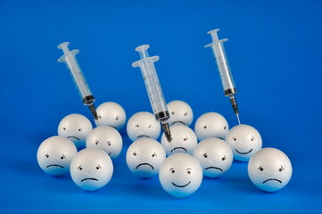 The concept of vaccination. Emotions concept. Happiness and depression faces.
