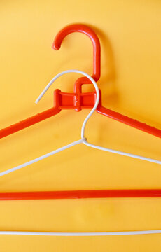 Clooth hanger in red and white color on yellow background