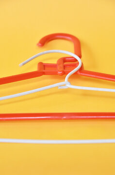Clooth hanger in red and white color on yellow background