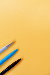 Colorful pens on yellow color background,education and background concept