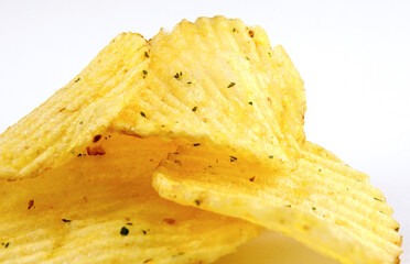 Riffled potato chips on a white background.