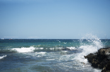 horizontal seascape with mountains in the background