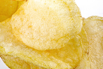 Delicious crispy potato chips on a white background.