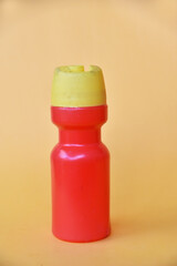 Plastic water bottle in red and yellow color on color background