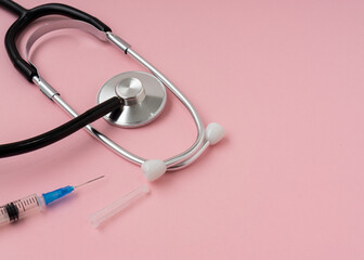 Stethoscope with a copy space on light pink background.