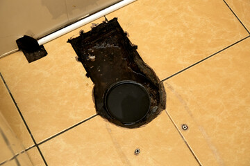 Sewer cleaning. A plumber uses sewer snake to clean blockage clog. Toilet room repair. Canalization...