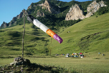 Flying windsock wind vane on mountine backgound, Check wind speed for paragliding in mountains